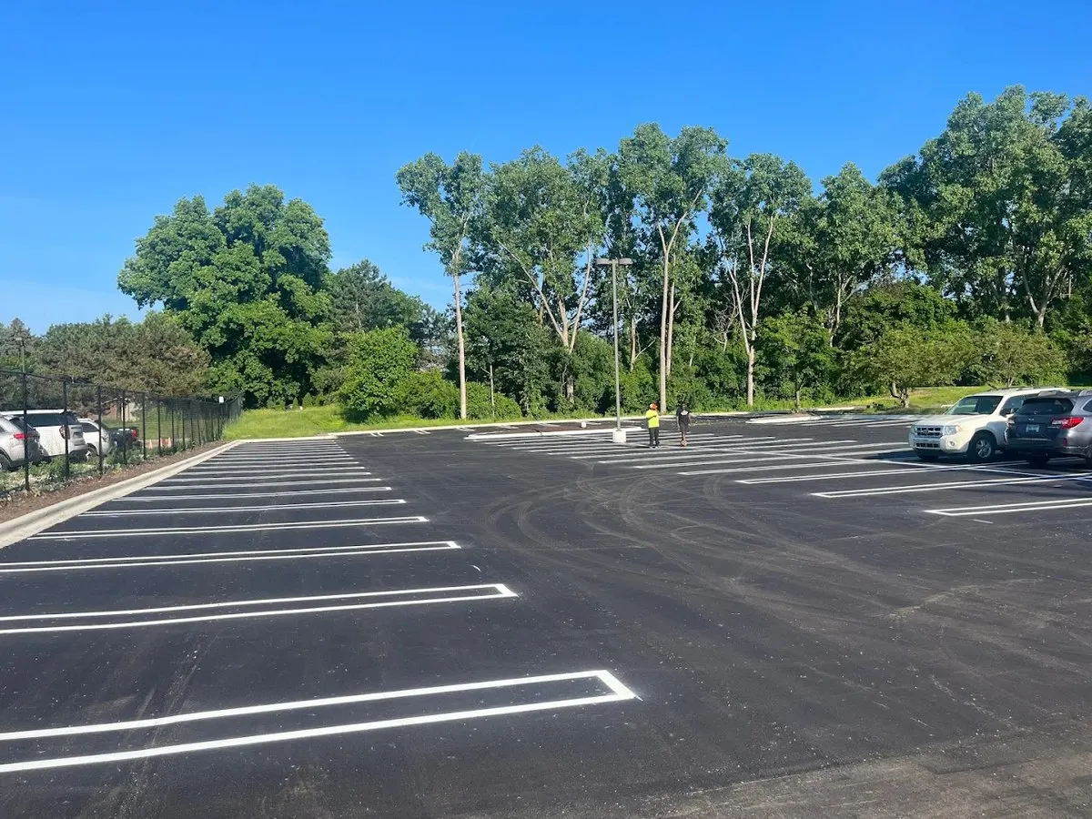 Freshly striped parking spaces on a clean blacktop commercial lot