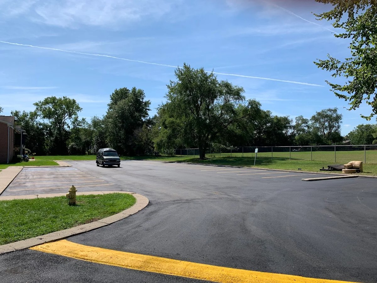 Parking lot with fresh asphalt and painted curb